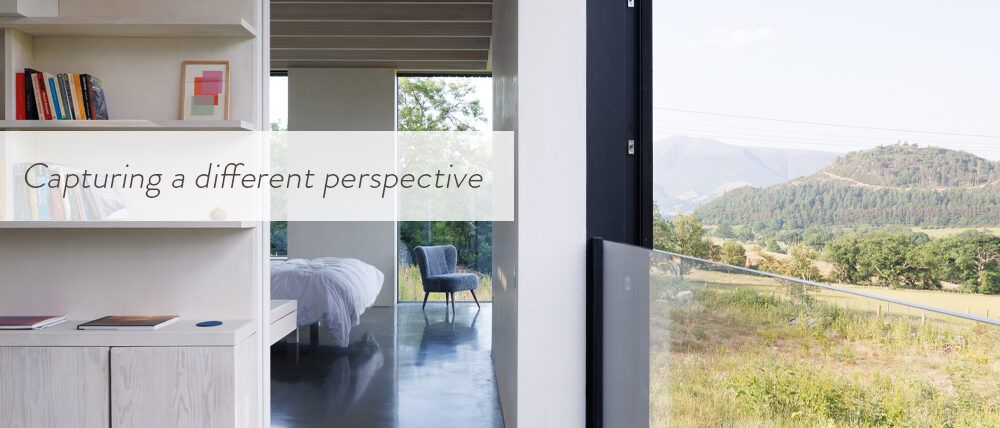 Overview of country house with minimal sliding doors looking out over landscape